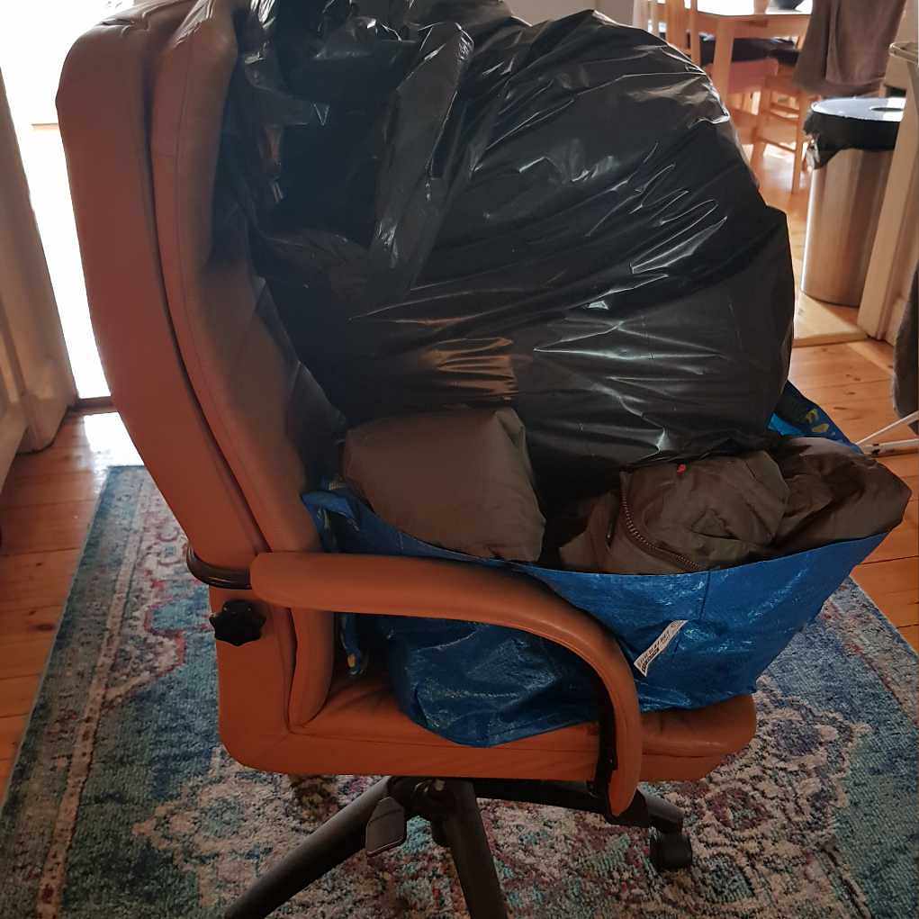 image of Chair and bag of clothes - Stockholm
