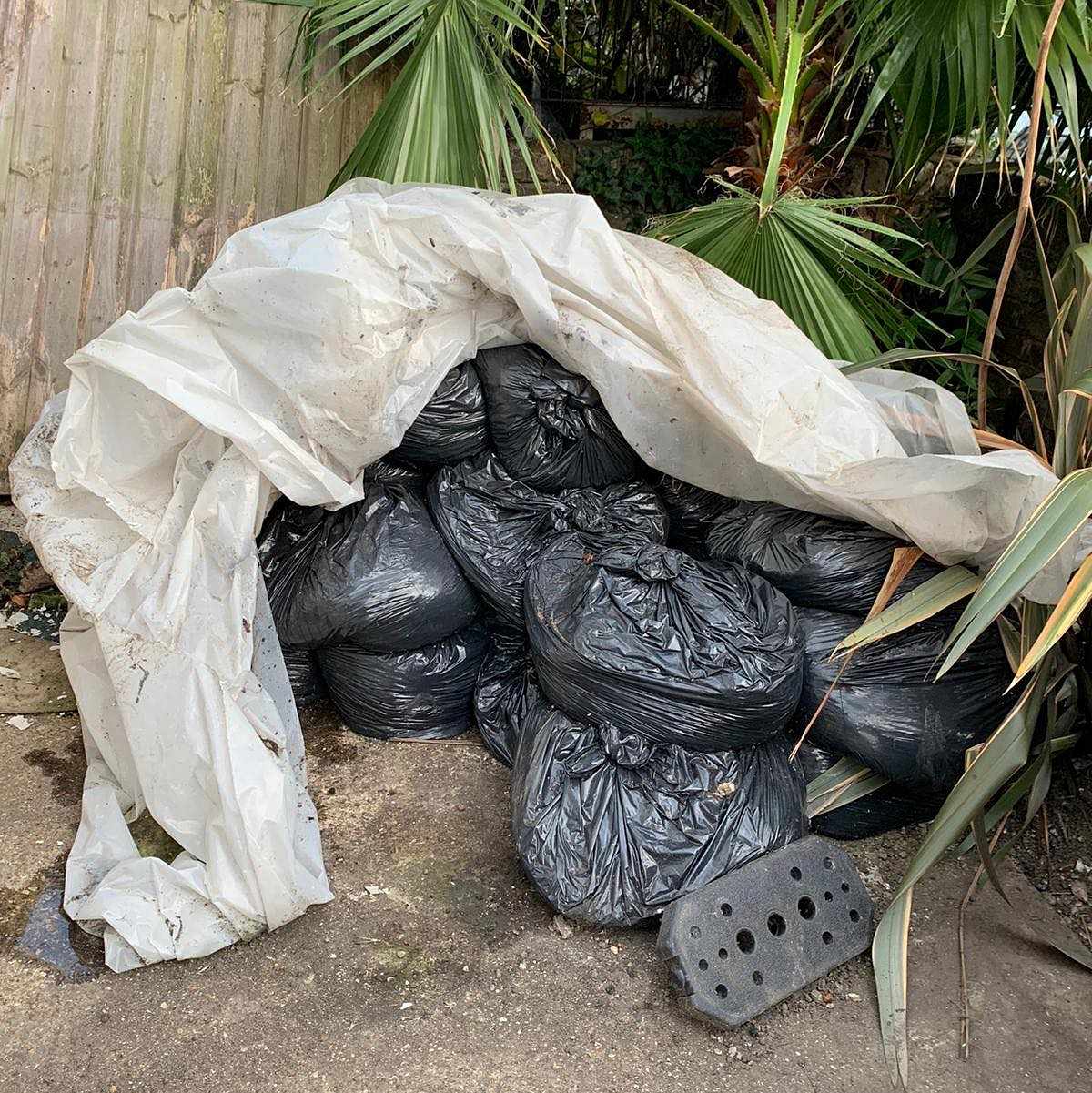 image of Black bags full of mud - Harlesden
