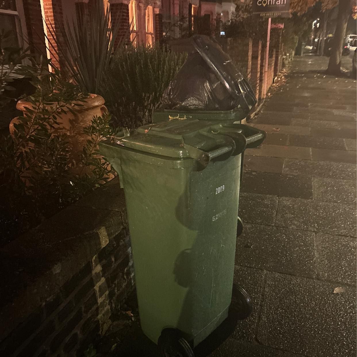image of Empty green and black bin - London