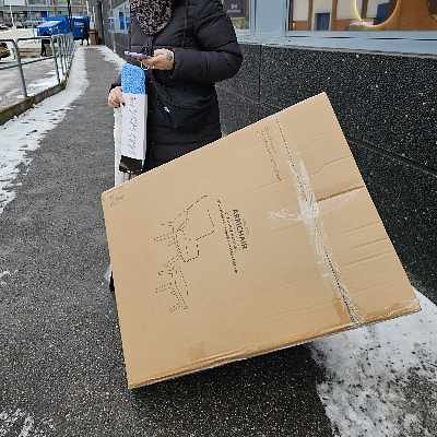 image of A big box and two people - 
